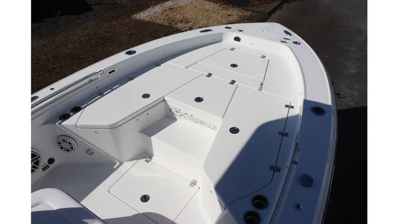 Slide: The Image of 2025 Crevalle 26 HCO boat deck with storage compartments and seating. - 8