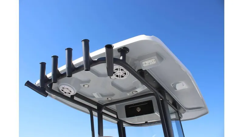 Slide: The Image of 2025 Crevalle 26 HCO boat T-top with rod holders against clear blue sky. - 9