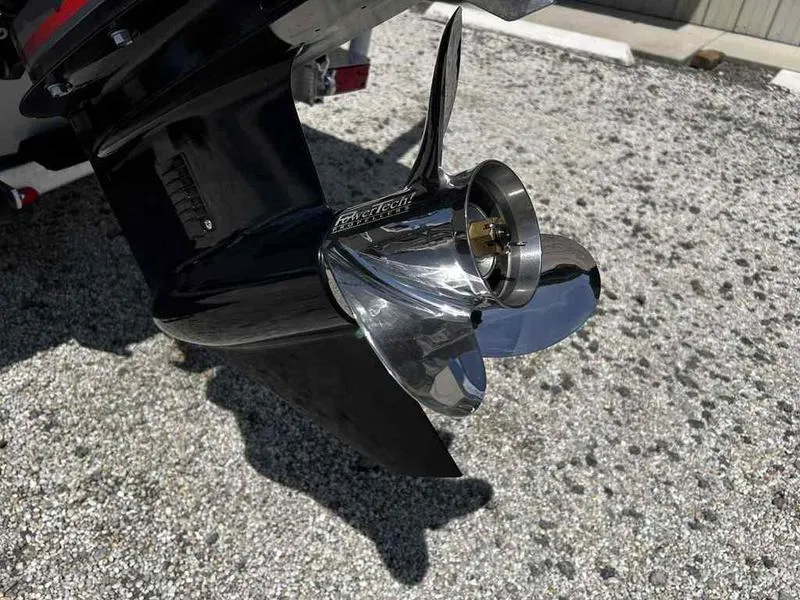 Slide: The Image of 2025 Xpress H190B boat propeller on gravel surface, showcasing sleek design and metallic finish. - 15