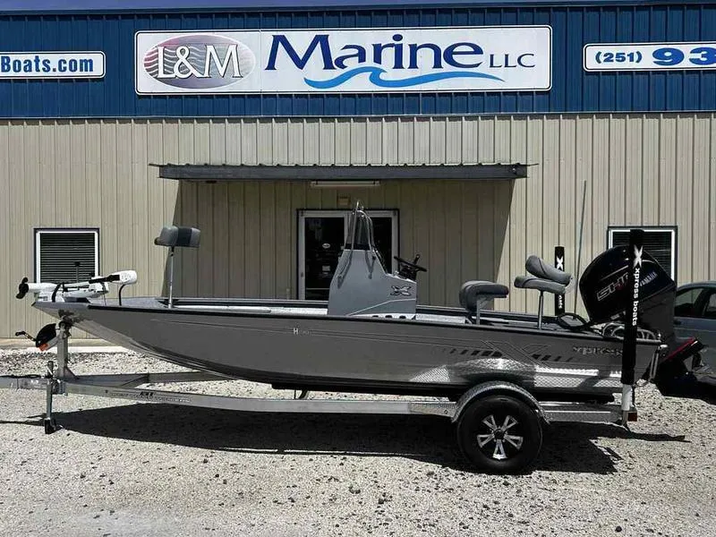 Slide: The Image of 2025 Xpress H190B boat on trailer outside L&M Marine LLC building. - 2