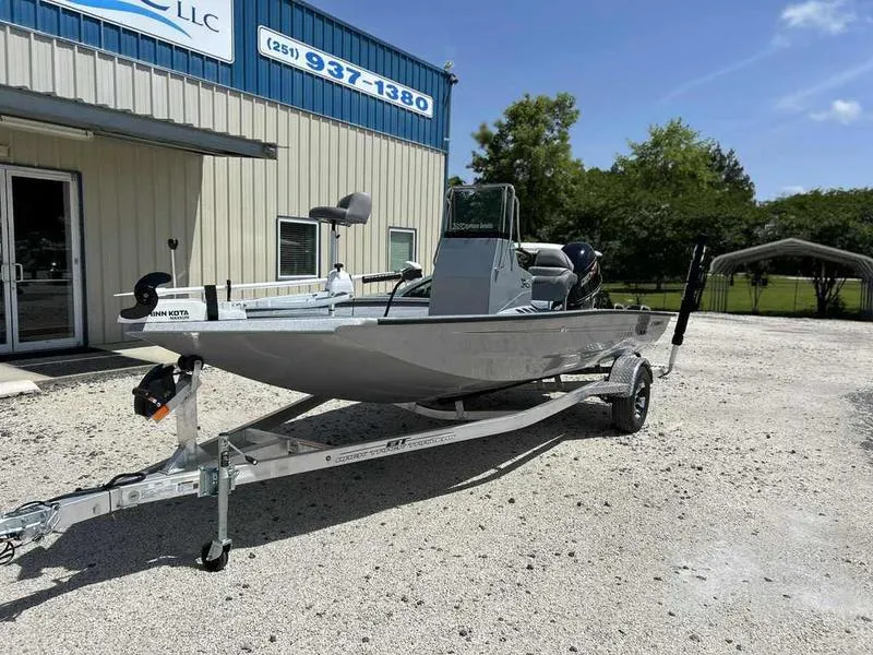 Slide: The Image of 2025 Xpress H190B boat on trailer outside a building under clear blue sky. - 3