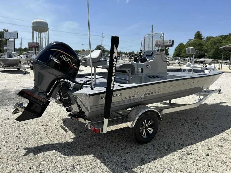 Slide: The Image of 2025 Xpress H190B boat with Yamaha engine on a trailer, parked outdoors. - 7