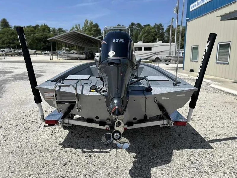 Slide: The Image of 2025 Xpress H190B boat with 115 HP engine, parked outdoors on gravel. - 8