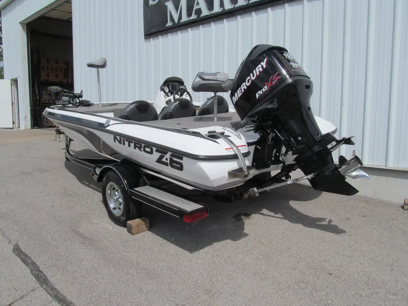 Slide: The Image of 2011 Nitro Z-6 boat with Mercury Pro XS engine parked outside a building. - 3
