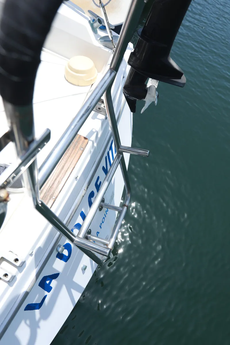 Slide: The Image of Sailboat ladder on 1988 Catalina 36, docked on calm water. - 11