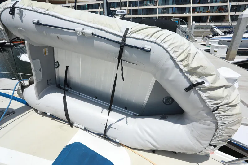 Slide: The Image of Inflatable dinghy secured on 1988 Catalina 36 yacht deck at marina. - 12