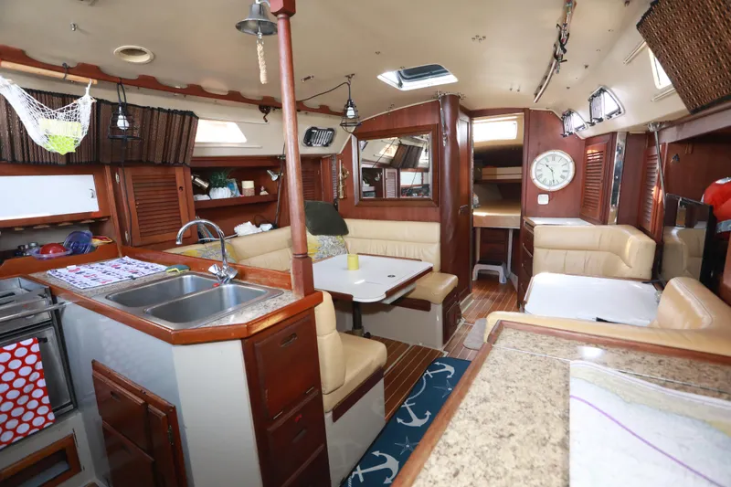 Slide: The Image of Interior of a 1988 Catalina 36 sailboat with cozy seating and kitchen area. - 19
