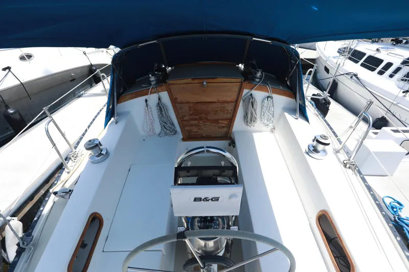 Slide: The Image of 1988 Catalina 36 sailboat cockpit with steering wheel, ropes, and canopy. - 23