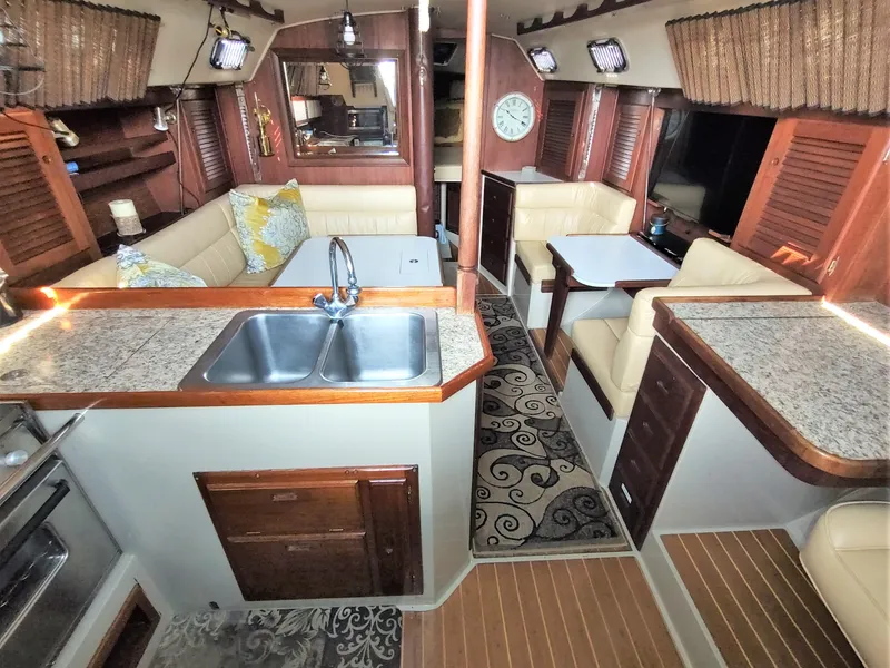 Slide: The Image of Interior of a 1988 Catalina 36 sailboat with kitchen and seating area. - 24