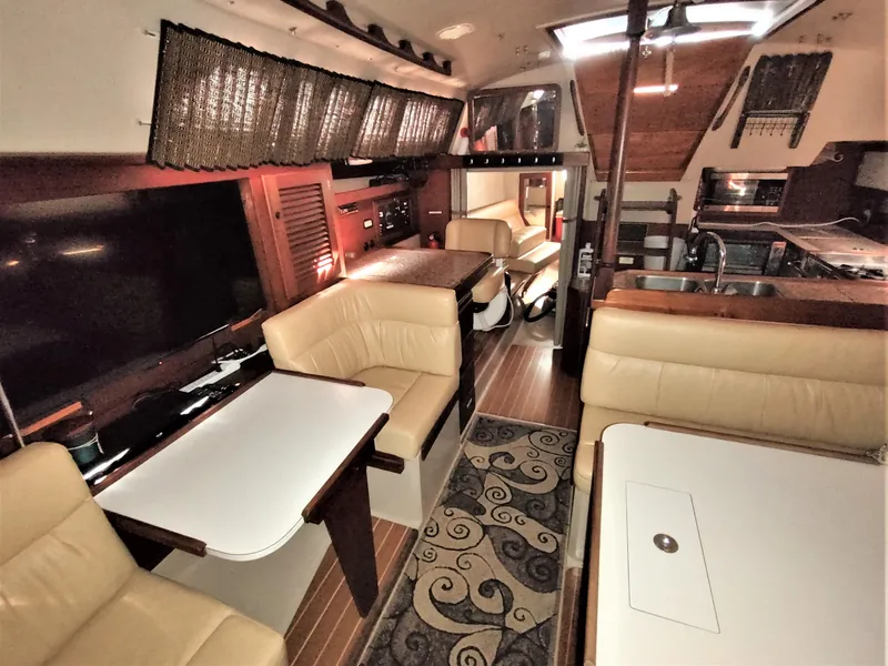 Slide: The Image of Interior of a 1988 Catalina 36 yacht with cozy seating and elegant wood finishes. - 26