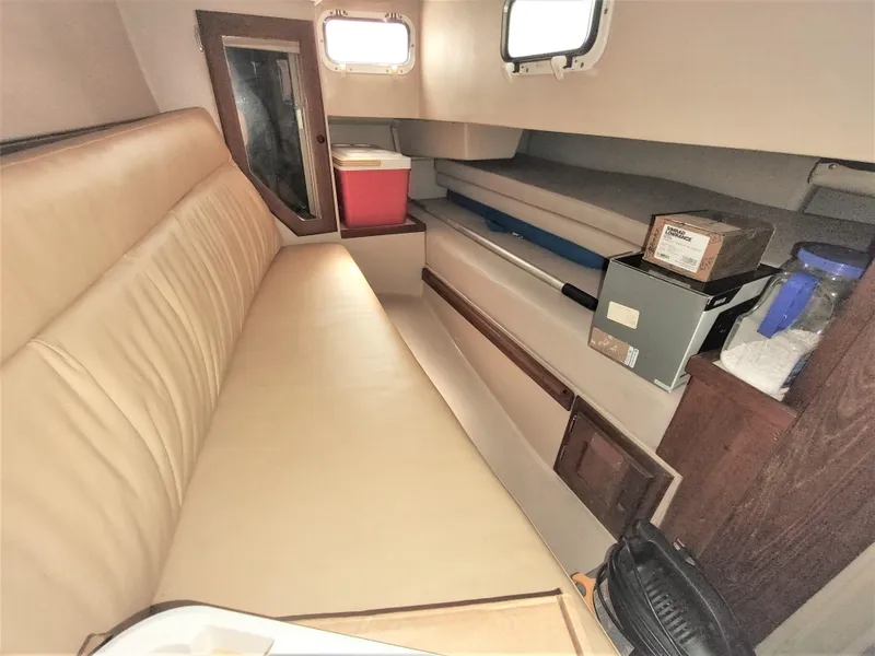 Slide: The Image of Interior of 1988 Catalina 36 sailboat with beige seating and storage compartments. - 27
