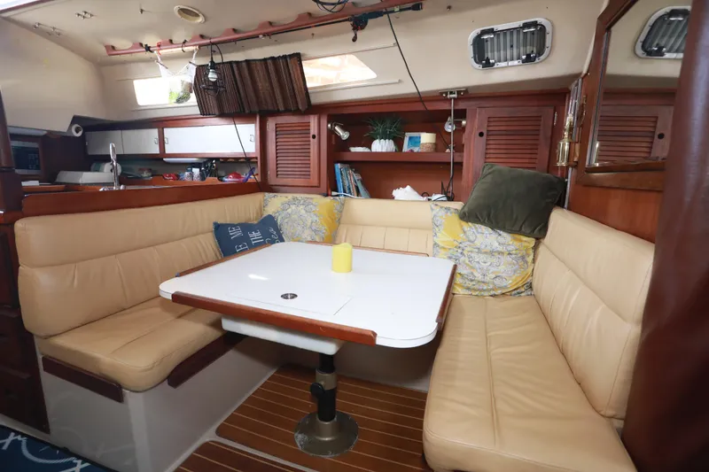 Slide: The Image of Interior of 1988 Catalina 36 sailboat with cozy seating and dining area. - 31