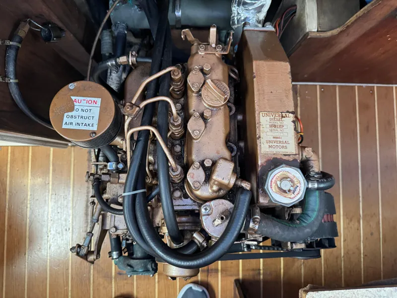 Slide: The Image of Engine of a 1988 Catalina 36 sailboat, showing detailed components and hoses. - 41