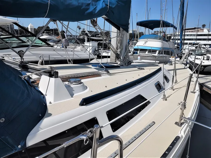 Slide: The Image of 1988 Catalina 36 sailboat docked at marina, featuring sleek design and blue sail covers. - 9