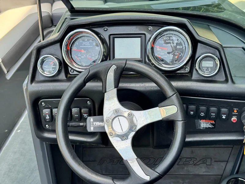 Slide: The Image of Dashboard of a 2014 Moomba Mondo boat with steering wheel and gauges. - 10