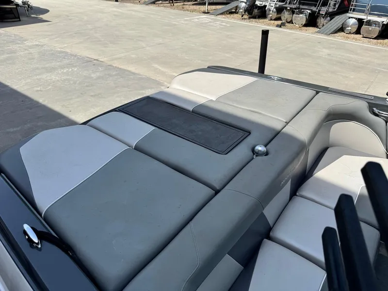 Slide: The Image of 2014 Moomba Mondo boat interior with gray and white cushioned seating. - 13