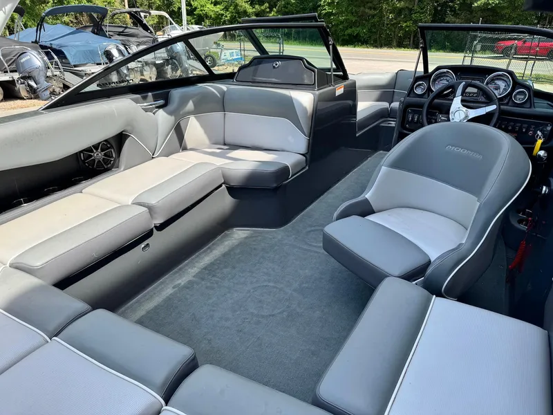 Slide: The Image of 2014 Moomba Mondo boat interior with gray seating and modern dashboard. - 15