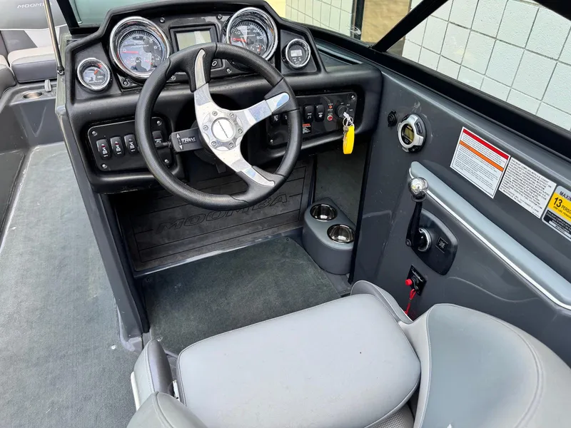 Slide: The Image of 2014 Moomba Mondo boat dashboard with steering wheel and control panel. - 20