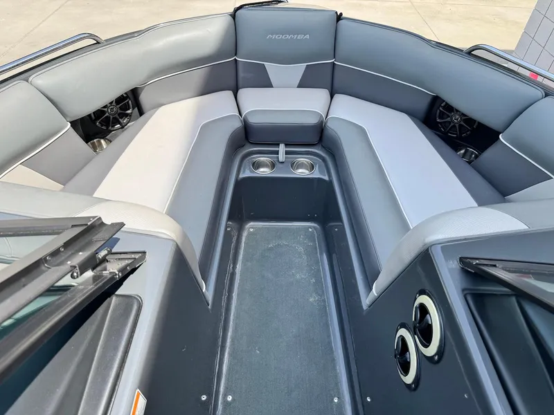 Slide: The Image of 2014 Moomba Mondo boat interior with gray seating and cup holders. - 21