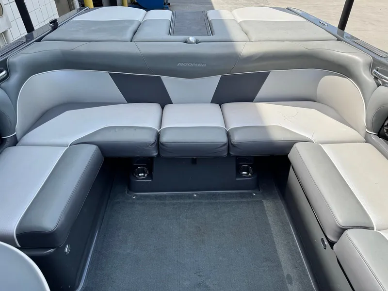 Slide: The Image of 2014 Moomba Mondo boat interior with gray seating and spacious layout. - 22