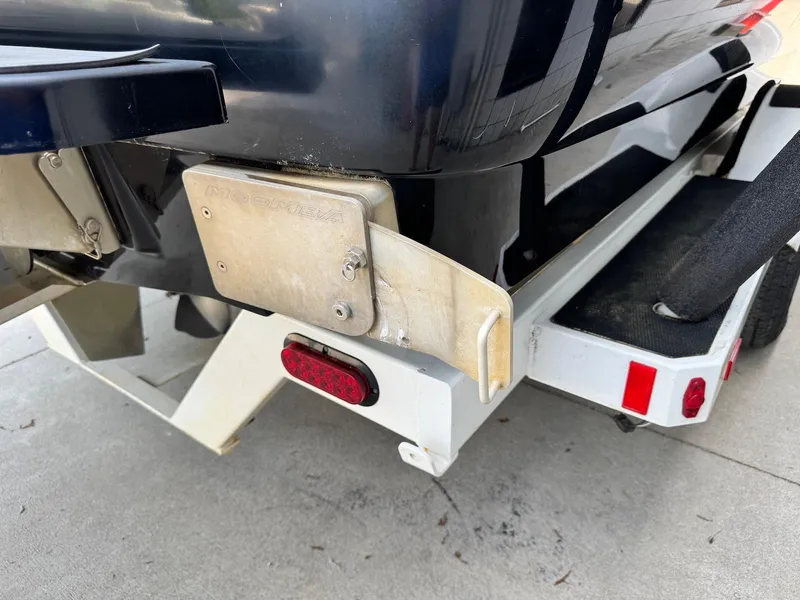 Slide: The Image of 2014 Moomba Mondo boat on trailer, rear view showing hull and trailer details. - 23