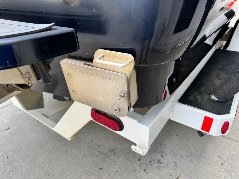 Slide: The Image of 2014 Moomba Mondo boat on trailer, rear view with visible swim platform and light. - 24