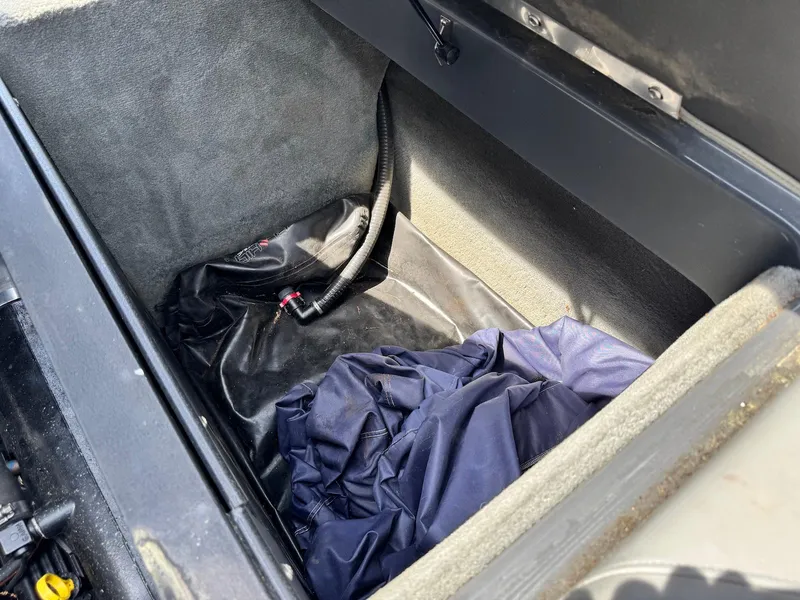 Slide: The Image of 2014 Moomba Mondo storage compartment with cover and hose inside. - 26