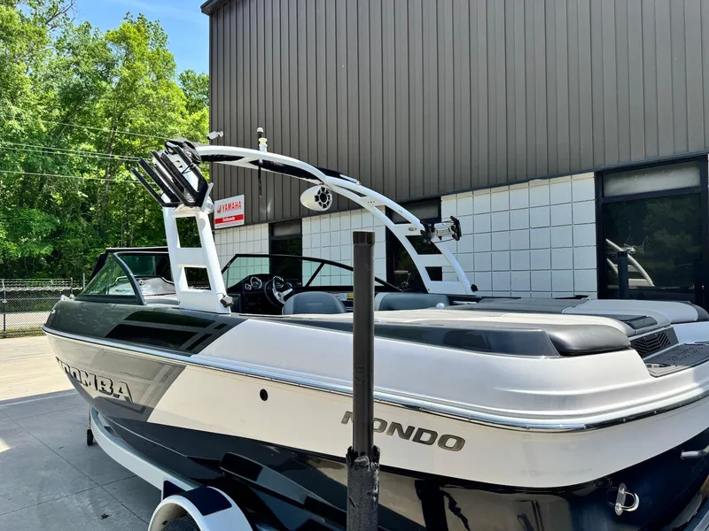 Slide: The Image of 2014 Moomba Mondo boat parked outside a building, featuring sleek design and modern architecture. - 3