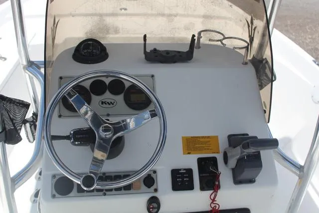 Slide: The Image of 2011 Key West 216 Bay Reef boat console with steering wheel and controls. - 17