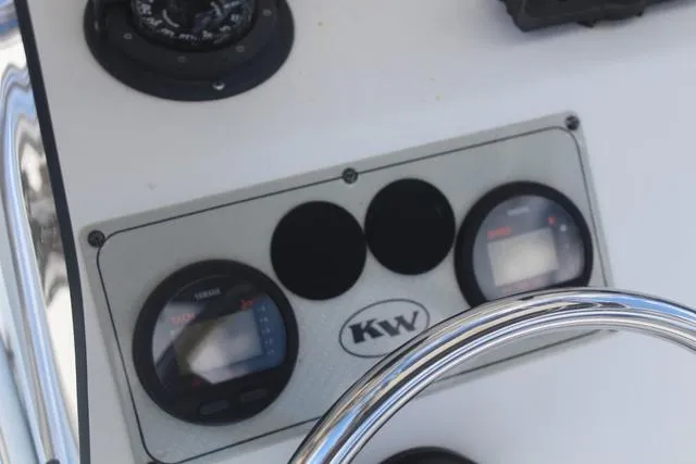 Slide: The Image of Control panel of 2011 Key West 216 Bay Reef boat with gauges and steering wheel. - 19