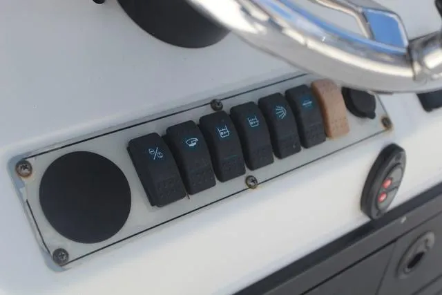 Slide: The Image of Control panel of a 2011 Key West 216 Bay Reef boat with labeled switches. - 20