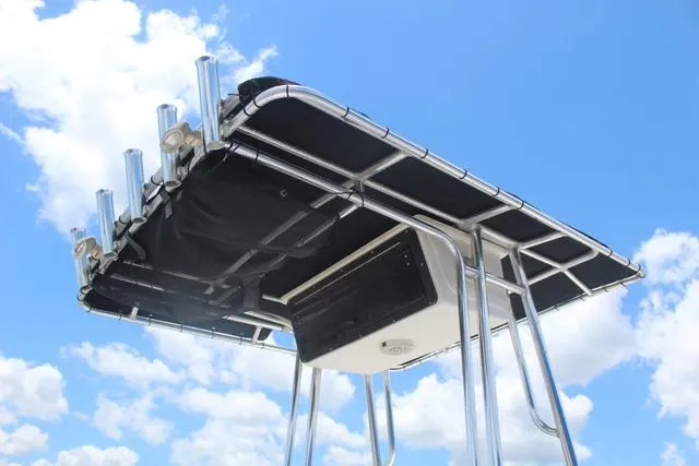 Slide: The Image of T-top of 2011 Key West 216 Bay Reef boat against a blue sky. - 22