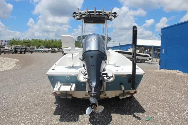 Slide: The Image of 2011 Key West 216 Bay Reef boat with outboard motor, parked on gravel lot. - 5