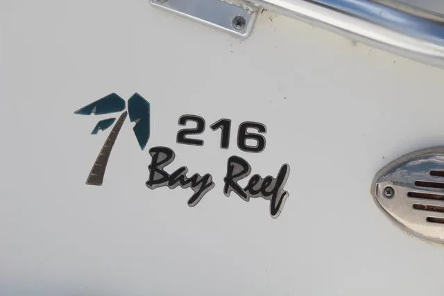 Slide: The Image of Key West 216 Bay Reef 2011 boat logo on white surface. - 9