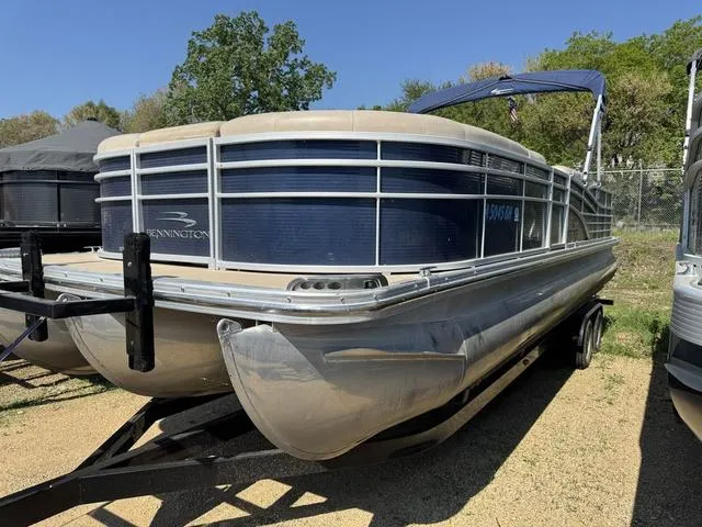 Slide: The Image of 2012 Bennington 2575 RCW pontoon boat on trailer, parked outdoors. - 1