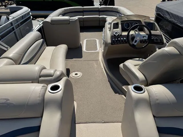 Slide: The Image of Interior of a 2012 Bennington 2575 RCW pontoon boat with beige seating and steering console. - 12