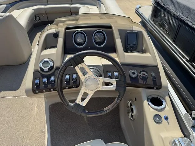 Slide: The Image of 2012 Bennington 2575 RCW boat dashboard with steering wheel and control panel. - 14