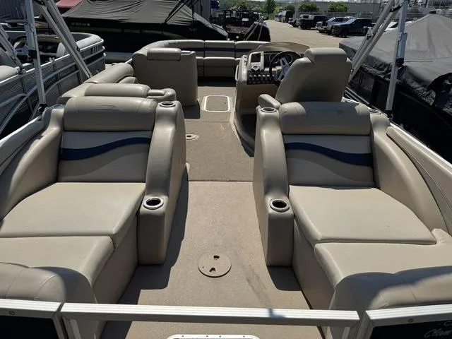 Slide: The Image of 2012 Bennington 2575 RCW pontoon boat interior with beige seating and steering console. - 17