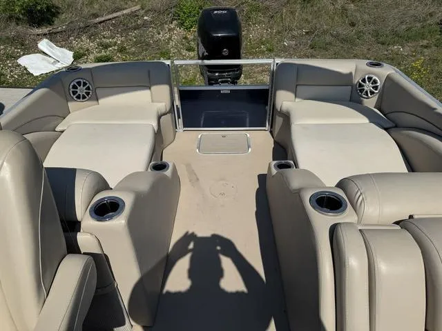 Slide: The Image of 2012 Bennington 2575 RCW boat interior with beige seating and cup holders. - 18