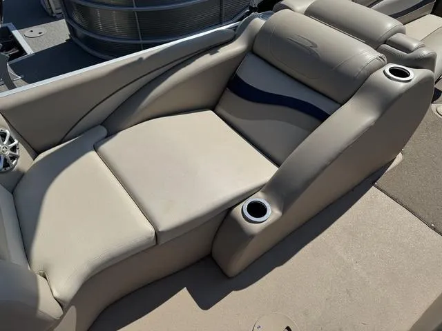 Slide: The Image of 2012 Bennington 2575 RCW boat interior with beige seating and cup holders. - 19