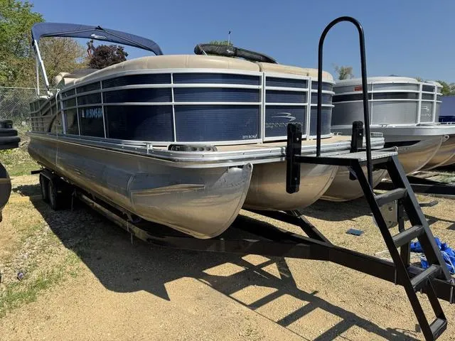Slide: The Image of 2012 Bennington 2575 RCW pontoon boat on trailer, parked outdoors. - 2