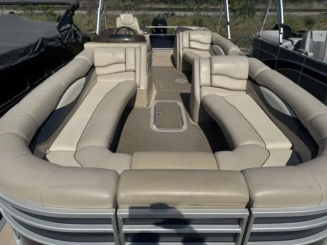 Slide: The Image of 2012 Bennington 2575 RCW pontoon boat with spacious beige seating and sleek design. - 7