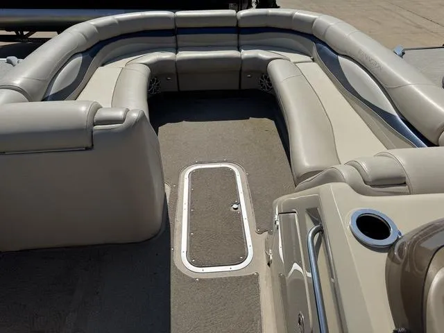 Slide: The Image of 2012 Bennington 2575 RCW pontoon boat interior with beige seating and carpeted floor. - 8