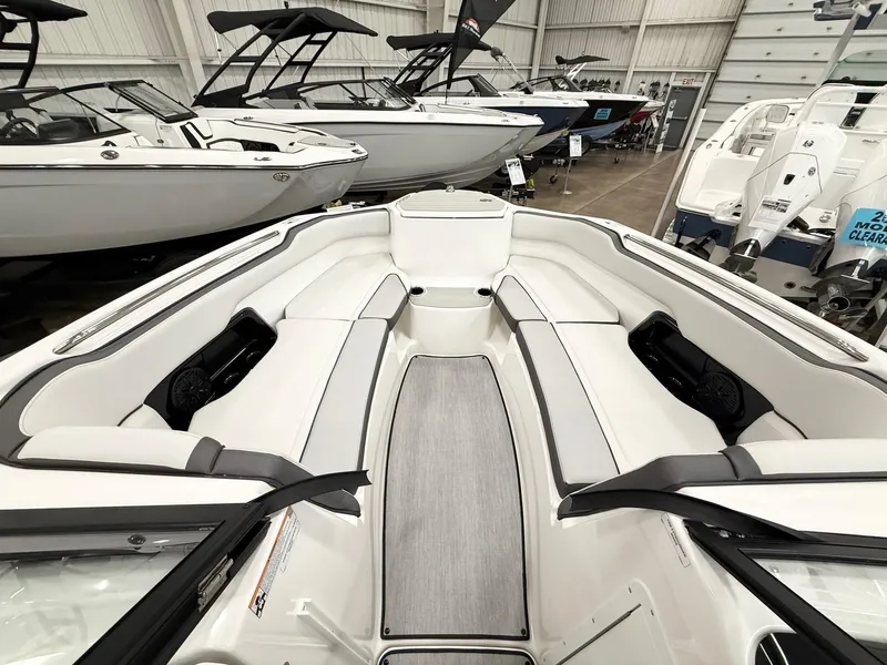 Slide: The Image of 2025 Yamaha Boats AR250 interior with sleek seating in a showroom. - 10