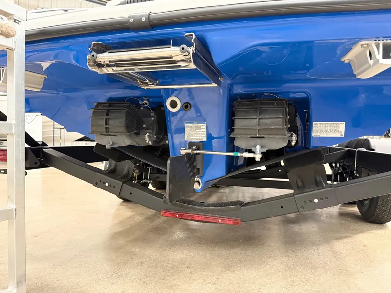 Slide: The Image of 2025 Yamaha Boats AR250, blue hull, dual jet engines, on trailer, rear view. - 3