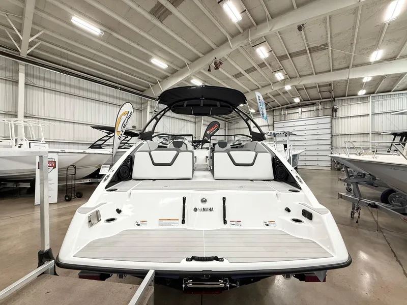Slide: The Image of 2025 Yamaha AR250 boat in showroom, rear view, sleek design, white interior. - 4
