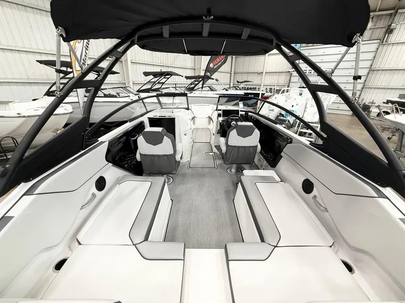 Slide: The Image of 2025 Yamaha Boats AR250 interior with sleek seating and modern design in a showroom. - 6