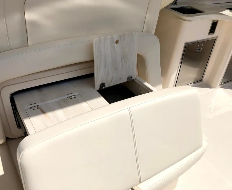 Slide: The Image of 2023 Grady-White Freedom 375 boat interior with white seating and storage compartment. - 13