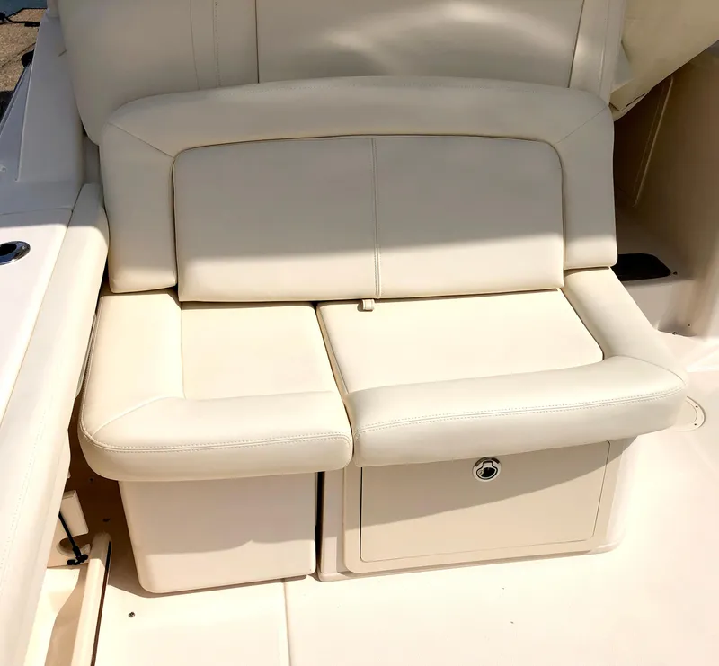 Slide: The Image of 2023 Grady-White Freedom 375 boat seat, cream leather upholstery, storage compartment. - 14