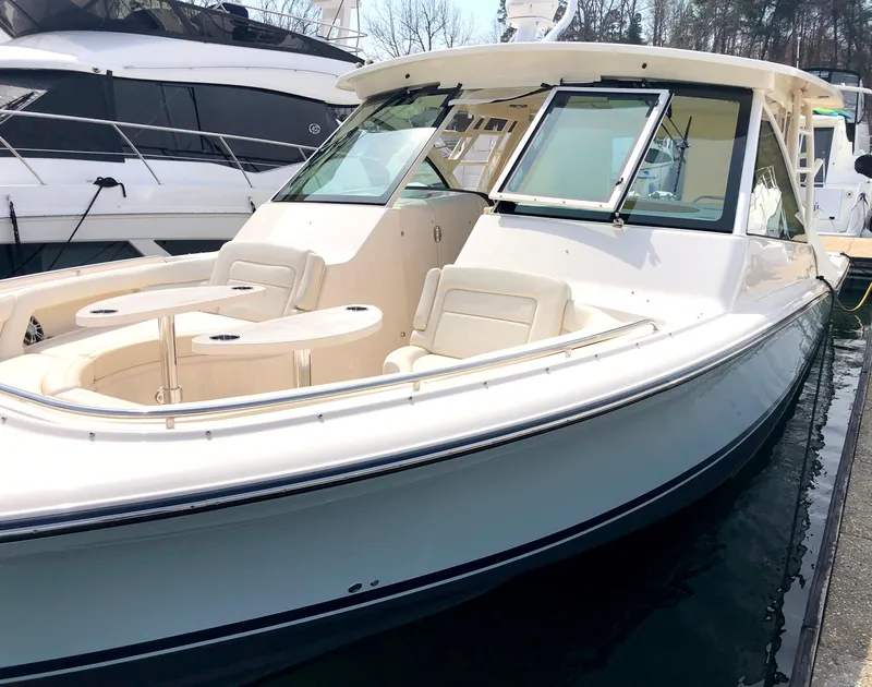 Slide: The Image of 2023 Grady-White Freedom 375 boat docked, showcasing sleek design and spacious seating. - 17